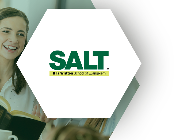 SALT: It Is Written School of Evangelism logo in a hexagonal shape over an image of a smiling young woman talking and holding an open Bible.